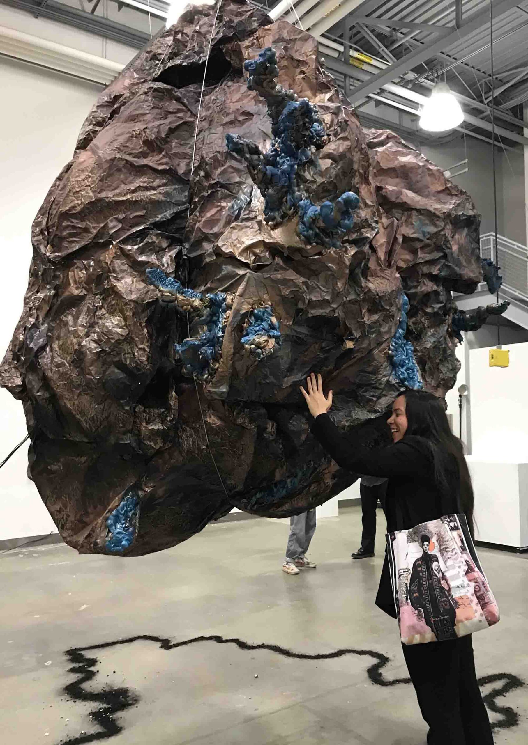 TRAVERSE-2 spectator hugging breathing boulder sculpture