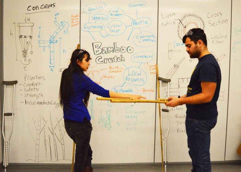 Picture1 two students explaining concept behind bamboo crutches