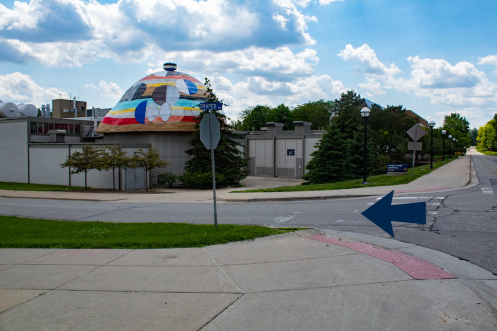 The back of Gorguze Family Lab and an arrow pointing down Draper Dr.