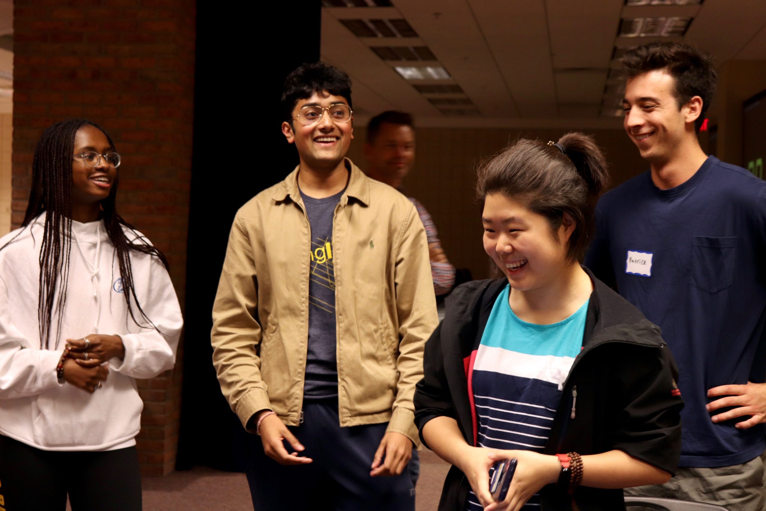 A group of students meeting each other and smiling together