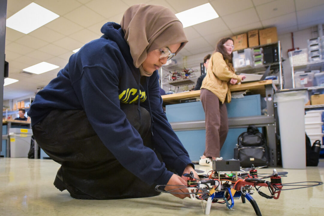a student fixing her drone