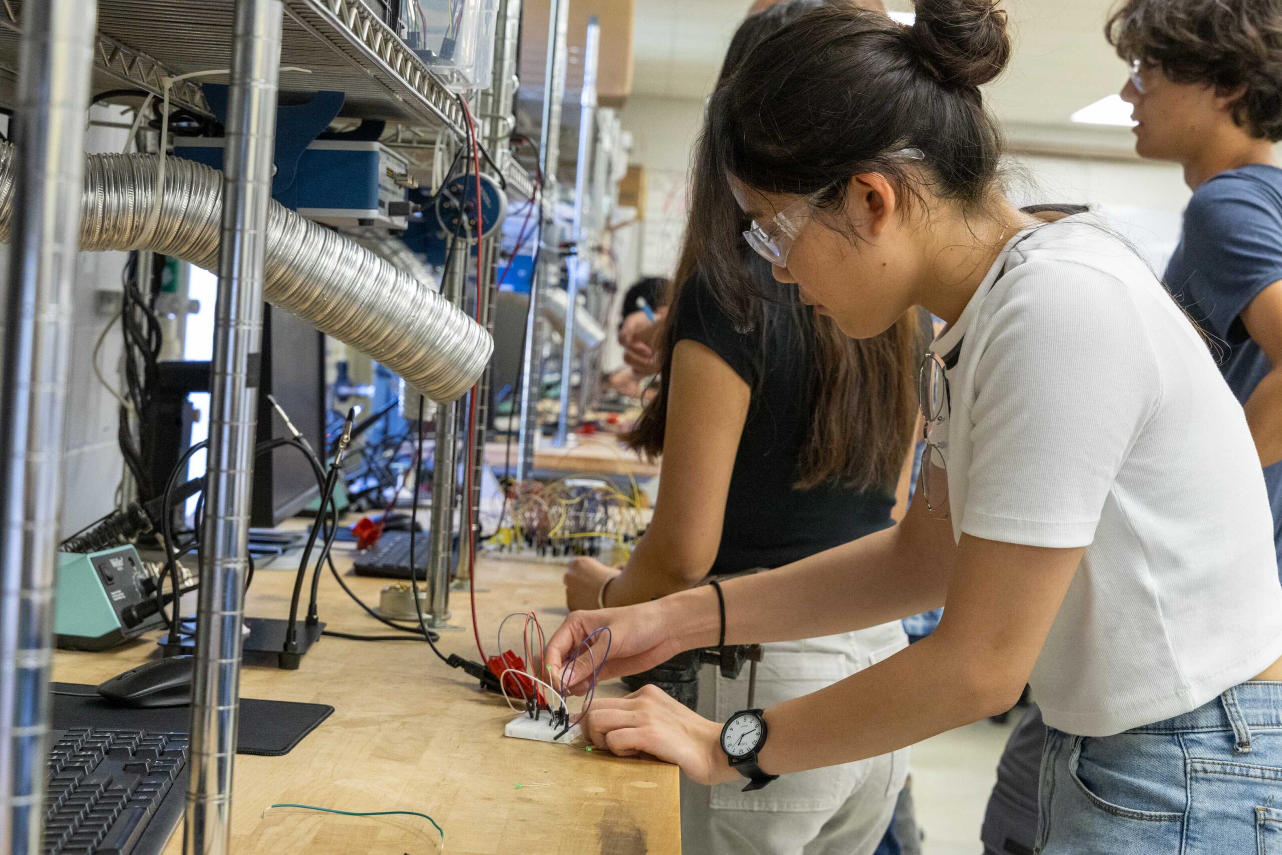 Sec 270 Bottom left(1) three students testing lab equipment